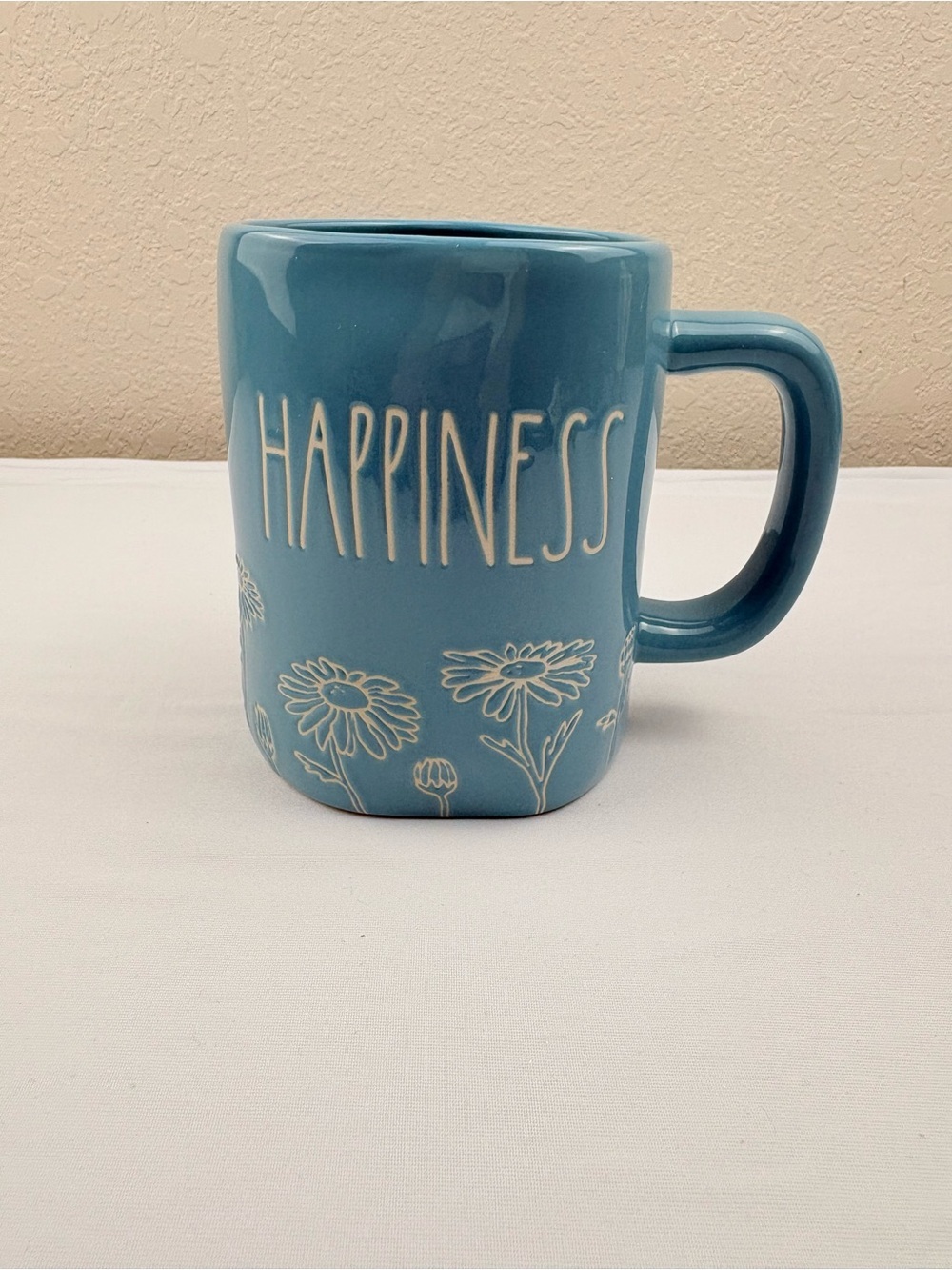 Rae Dunn artisan collection “HAPPINESS” mug in a teal color with flowers